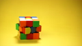 Rubiks cube at yellow background 89119658