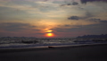4K footage of a sunset on the beach with a stunning outdoor landscape in the background. 89298191