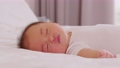 Happy asian newborn baby lying sleeps on a white bed comfortable and safety.Cute Asian newborn sleeping and napping at warmth place deep sleep and fresh breathing.Newborn Baby Sleep concept 89723830