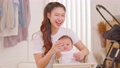 Happy asian mom playing and spending time with her newborn baby and looking at camera together at home.Adorable baby boy smile laughing with mother in warmth place relax and comfortable.good moment 89723847