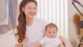 Happy asian mom playing and spending time with her newborn baby and looking at camera together at home.Adorable baby boy smile laughing with mother in warmth place relax and comfortable.good moment 89723848