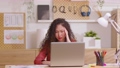 Asian woman sitting at desk in front of laptop stressed out face and headache shows her stressful  with work from home office. Female thinking about work mistake or workload has depression. 89723854
