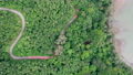 Top view of countryside road passing through the green forrest and mountain 90368094