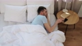 man sleeping in bed checking time on smartphone 90808952