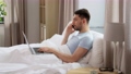 man with folder calling on phone in bed at home 90808961
