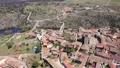 Scenic drone view of historic center of Ledesma town on banks of Tormes river surrounded by ancient defensive wall on sunny spring day on background of large natural rural landscape, Salamanca, Spain 90973144