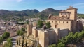 Panoramic aerial view of Caravaca de la Cruz cityscape overlooking medieval fortress and basilica, Murcia, Spain 90973152