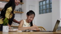 Asian mother teaching, helping daughter with homework while sitting at home kitchen. E-learning education, homeschooling concept 90989225