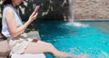 girl use phone on pool 91100030