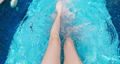 girl kicking feet underwater 91100039