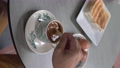 Man stirring hot coffee, having breakfast in a cafe.  93188054