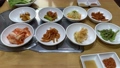 Traditional Korean food with small side dishes called banchan in a restaurant.  Top view shot. 93437553