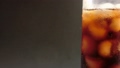 右端で回転する氷とコーヒーが入ったドリンクボトル　映写機で撮影したような古めかしい映像効果 94211757