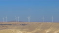 Wind turbines in the desert with blue sky background. Wind farm in Jordan desert 94344443