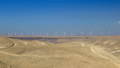 Wind turbines in the desert with blue sky background. Wind farm in Jordan desert 94344445
