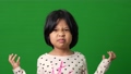 Portrait of Asian angry and sad little girl on green screen background, The emotion of a child when tantrum and mad, expression grumpy emotion. Kid emotional control concept 94442437