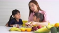 Enjoy Asian mom teaching a little daughter holding knife cut fresh vegetables, Happy family mother and child girl preparing vegetarian vegetable salad at home, Happy family enjoy activity together. 94442440