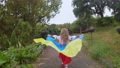 Ukrainian girl child runs with a flag in her hands. 94515629
