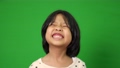 Portrait of happy, smiling, and funny Asian child girl on green screen background, a child looking at camera. Preschool kid dreaming fill with energy feeling healthy and good concept 94552535