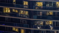 Evening view of exterior apartment recidential building timelapse with glowing windows 94577937