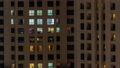 Evening view of exterior apartment recidential building timelapse with glowing windows 94577939