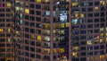 Evening view of exterior apartment recidential building timelapse with glowing windows 94577942