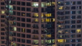Evening view of exterior apartment recidential building timelapse with glowing windows 94577943