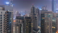 Dubai skyscrapers with illumination in business bay district during all night timelapse. 94577946