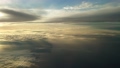 夕日に染まる日没直前の雲上を飛ぶ飛行機からの幻想的な光の風景 94582667