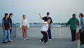 cool girl is breakdancing and pumping on street dance party, youth hang out on roof in summer 94587597