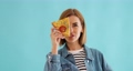 woman covering her eyes with a slice of fresh pizza 95443546
