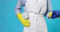 woman in gloves and apron holding rag and toilet brush 95571349