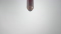 Drop of brown liquid, oil, serum or tincture dripping from pipette on a gray background. Macro shot of dripping drops of iodine or essential oil. Concept of medicine, health, treatment. Aroma, herbal 96344552