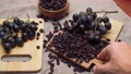 Dried black raisins in wooden bowl, woden background. Selective focus 96395089