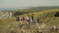 Family with backpacks walking along hiking trail in slow motion. 96522288