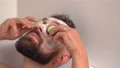 man put on cucumber on face in bath at home 96552548