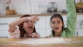 Two beautiful women play with flour in the kitchen 96706750