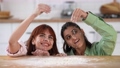 Two beautiful women play with flour in the kitchen 96706760