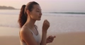Female Runner Jogging With Earphones During Outdoor Workout on the Beach in Slow Motion 96900494