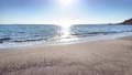 The beach at Nagahama Beach where the sunlight reflects off the waves and sparkles 99929097