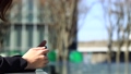 Woman using a smartphone outdoor business image 100143515