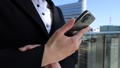 Woman using a smartphone outdoor business image 100143525